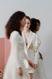 A striking photo capturing a woman in a white jacket amidst dynamic, blurred movement.
